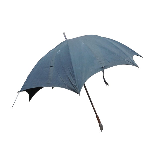 This antique walking-stick style umbrella showcases exceptional character, highlighted by an expressive, figural...