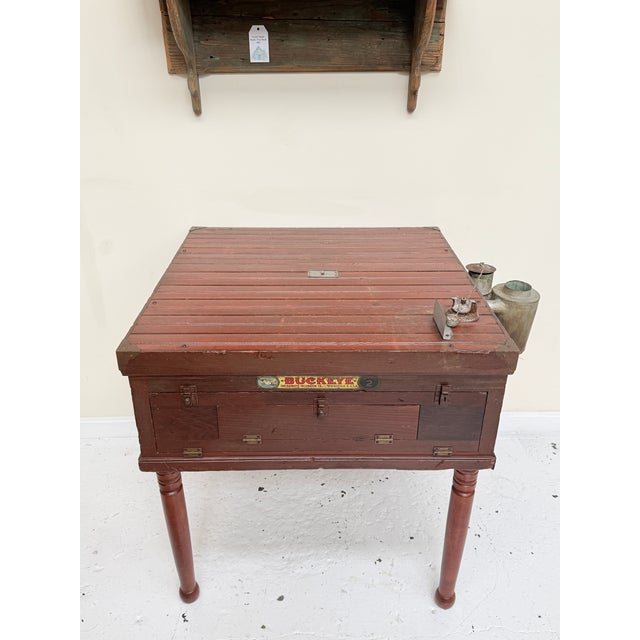 This unique piece began its life as a Buckeye poultry incubator, a turn‑of‑the‑century wooden cabinet designed to keep...