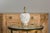A Midcentury Italian white pottery table lamp with textured body and carved gilt wood base on round lucite. Emanating an...