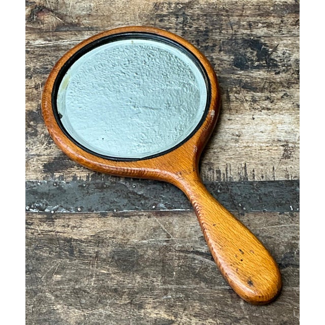 Celebrating the graceful elegance of the Art Nouveau movement, this vintage handheld mirror is expertly crafted from solid...