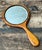 Celebrating the graceful elegance of the Art Nouveau movement, this vintage handheld mirror is expertly crafted from solid...