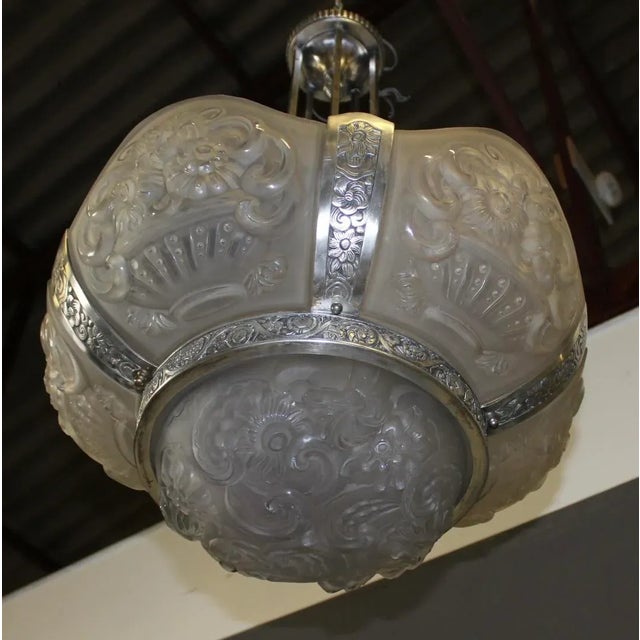Important chandelier with pressed glass and nickel-plated brass plates, Art Deco period around 1930, it consists of a bowl...