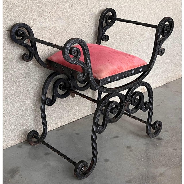 Stylish wrought iron Curule bench made in the neoclassical taste. Featuring an X-form design with scrolled arms and feet....