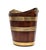 A 19th century Dutch boat shaped bucket with coopered mahogany staves bound with two wide and three narrow brass bands,...