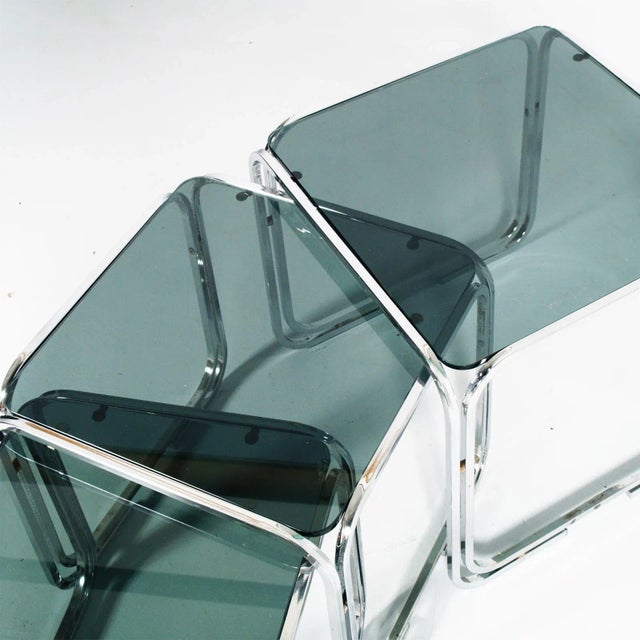 This is a set of Italian mid-century glass fumè and chromed tubular steel nesting tables in the Marcel Breuer style. This...
