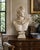 A large neoclassical plaster bust after the celebrated Apollo Belvedere, modeled with the god’s idealized profile,...