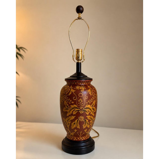 Beautiful vintage Italian-style ceramic table lamp featuring a rich oxblood red finish with elegant gold Florentine-...