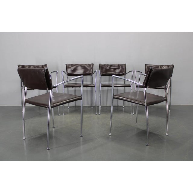 A refined set of six mid century modern armchairs produced by Arper in Italy during the 1980s. The chairs combine elegant...