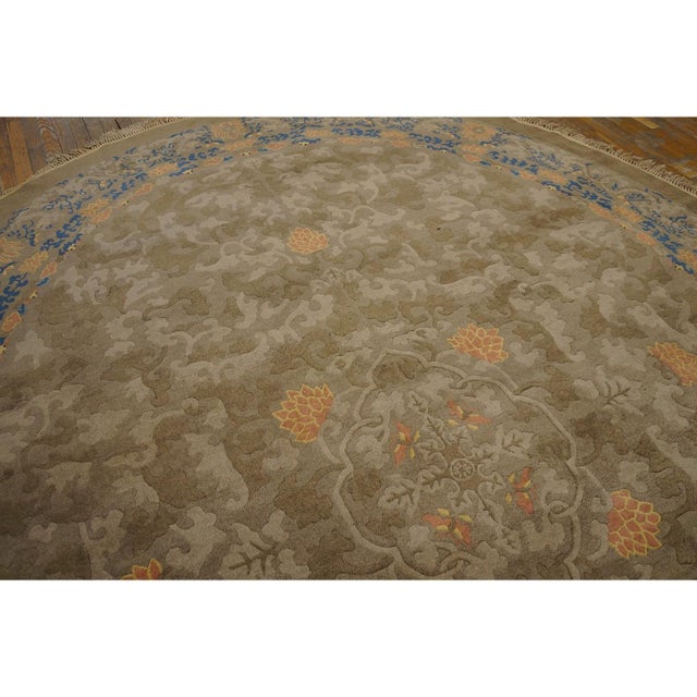 Antique Peking Oval Room Size Wool Mocha Rug, Circa Date: 1900s. This exceptional Chinese Peking carpet presents a rare,...