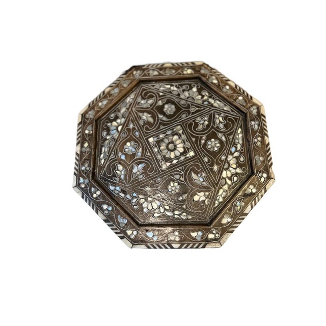 The intricate foliage arabesque inlay, crafted from mother-of-pearl, bone, and silver, is a rare and exquisite art form....