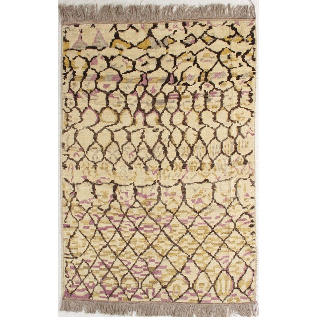 Hand-knotted Moroccan rug featuring an allover lattice pattern rendered in dark brown over a warm beige field. The design...