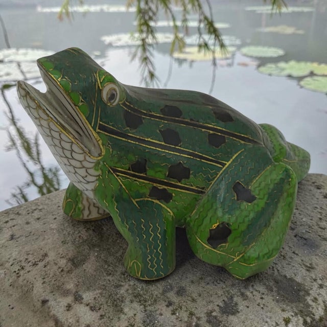 This Whimsical Cloisonne Hand Painted Enamel Frog Figurine is a delightful collectible piece made of brass, featuring a...