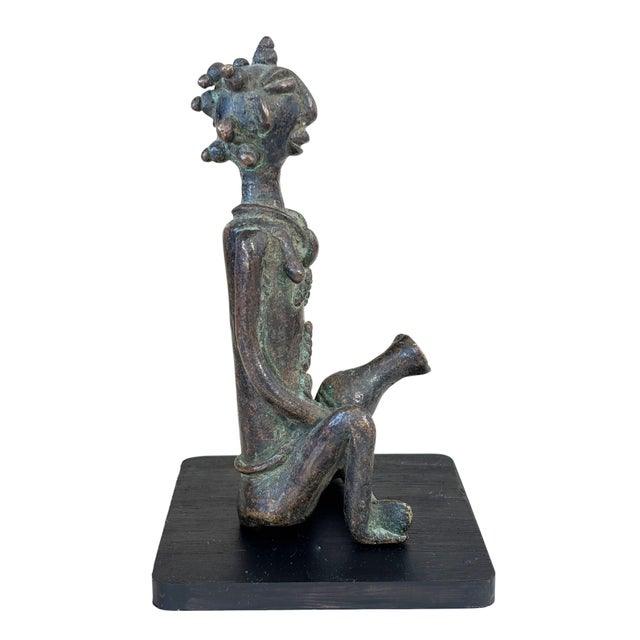 This 6" tall and 6.5" with the stand Benin bronze statue of a seated woman with a Jar is a must-have for collectors. The...