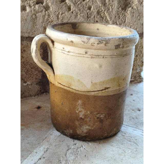This two-handled terracotta salt jar, handcrafted in Southern Italy, was originally used to preserve olives and other...