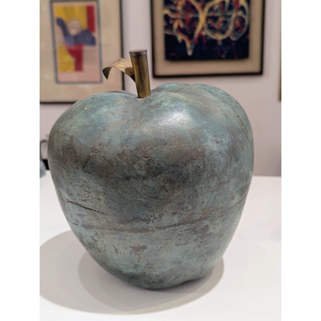 Designers leaned into scale and weight, turning familiar forms into permanent fixtures. This oversized cast metal apple...
