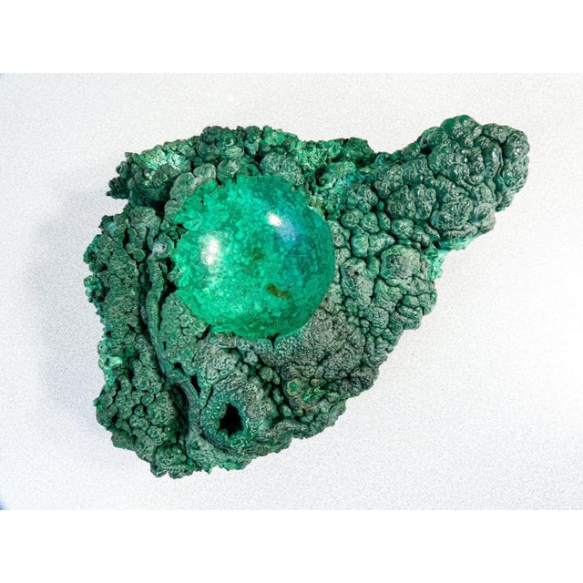 Rough malachite cluster sculpture, with central recess carved and polished material rough malachite, with central hollow...