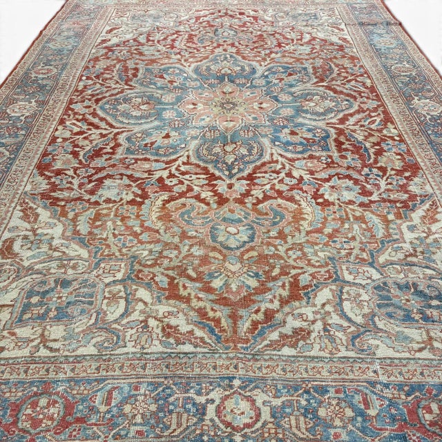 This stunning antique Heriz rug is a remarkable example of Persian craftsmanship, blending bold structure with refined...