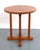 1960s Mid Century Modern medium toned English oak table with beveled supports and a cross-brace base. Manufactured by Ford...
