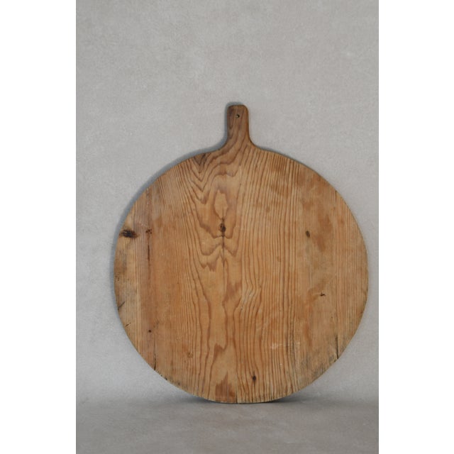 This early 20th Century antique European breadboards was hand-carved from solid wood. Perfect for layering on a kitchen...