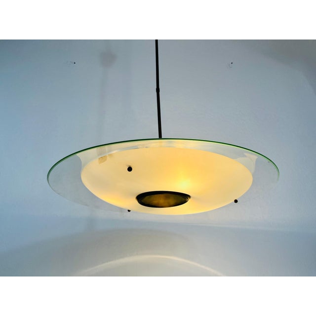 A Sputnik chandelier made in Italy in the 1950s. It is fascinating with its unique saucer shape and wonderful glass...