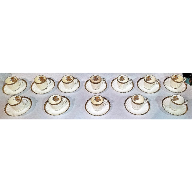 Elegant set of 12 Minton demitasse porcelain cups and saucers, bone with 23k gold trim and decor. 3 of the cups with...