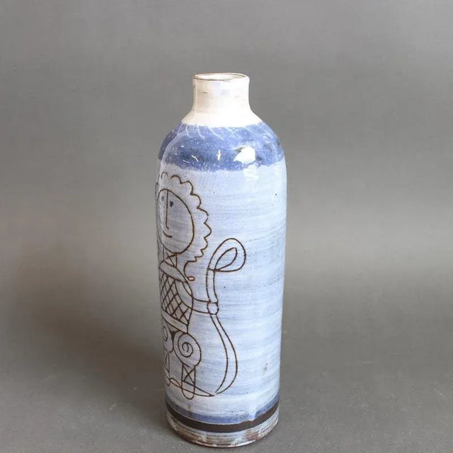 An elegant cylindrical ceramic vase dating to the 1960s by Michel Barbier. The form is refined, with a narrow lip and a...