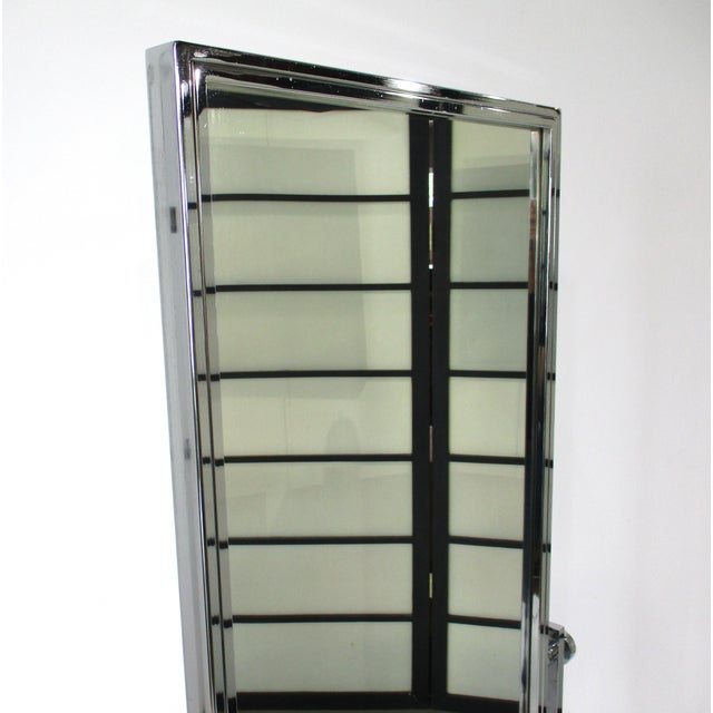 A vintage polished chrome full length rolling two- sided dressing room mirror with nice large roller feet, this...