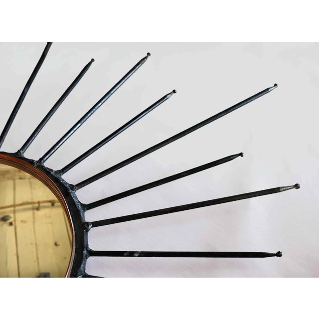 Vintage mid century custom made iron starburst wall mirror. Iron and metal fabrication with brass tips and a mirror that...