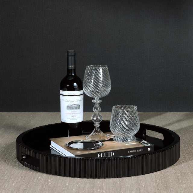 A striking blend of elegance and functionality, this round lacquered MDF tray features a high-gloss black finish that adds...