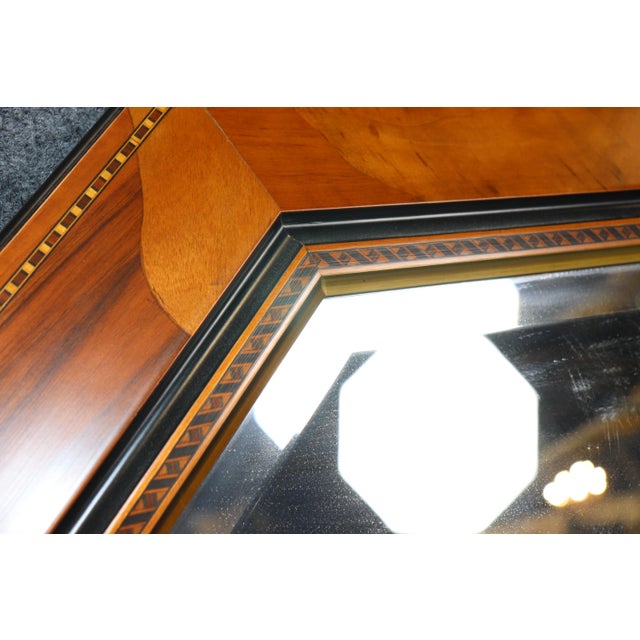 An elegant and highly decorative octagonal inlaid mirror, beautifully crafted with richly figured walnut veneers and...