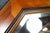 An elegant and highly decorative octagonal inlaid mirror, beautifully crafted with richly figured walnut veneers and...