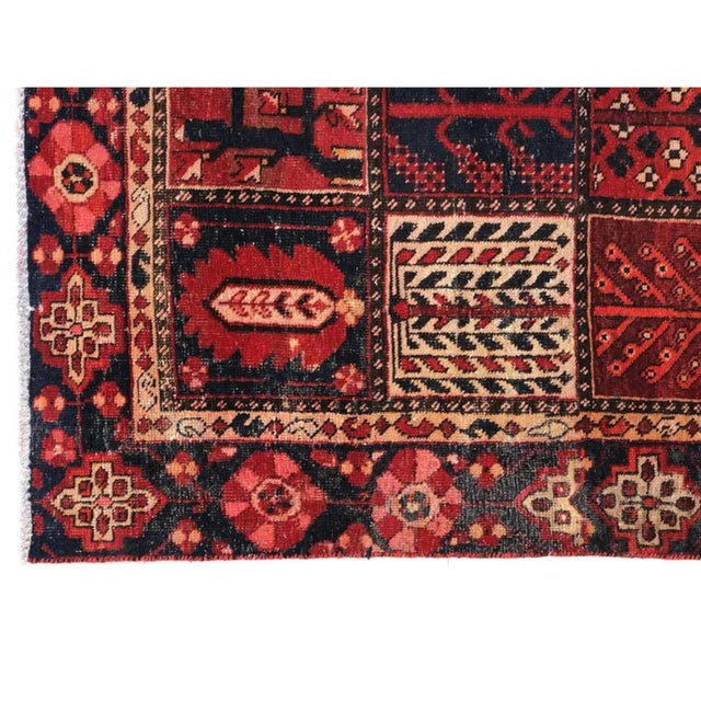 Vintage hand-knotted Bakhtiari rug featuring the classic Kheshti garden panel design, with individual compartments filled...