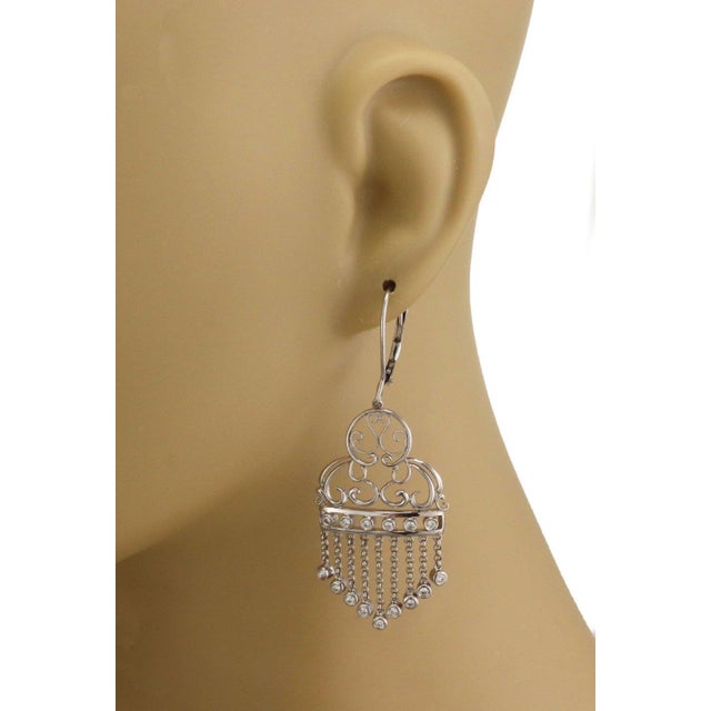 This is a beautiful pair of Estate earrings, they are crafted from 14k white gold with a polished finish featuring hook...