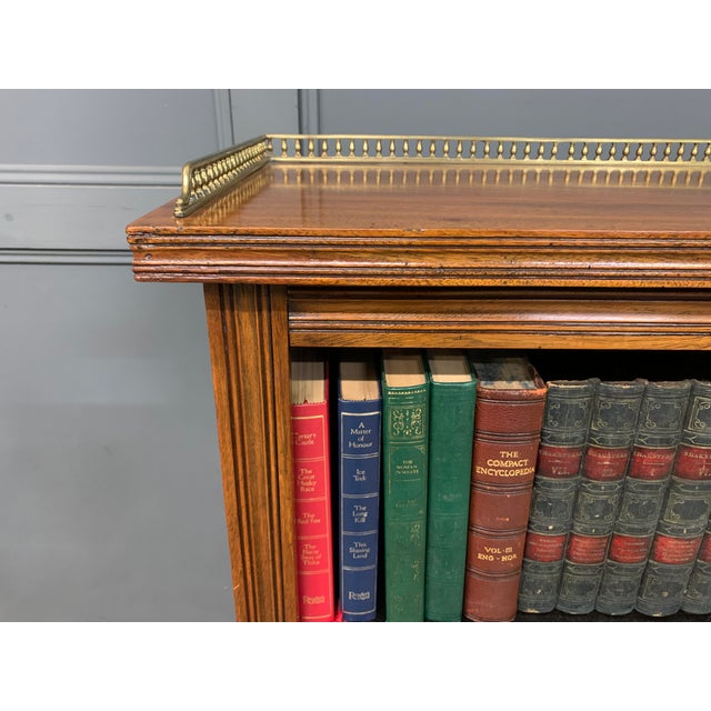 A good late Victorian period open bookcase. Of very good construction in solid walnut with a lovely pierced brass gallery...