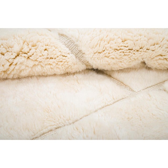 Luxurious hand-knotted wool rug with a shaggy texture in soft Ivory tones. Featuring modern geometric accents, this...