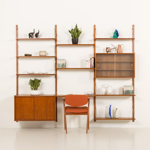 This elegant danish teak wall unit was made in the 1960s, in randers, denmark. It's a part of the modular ps system...