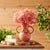 Bring soft elegance to your space with the Stoneware Vase with Floral Accent. Featuring soft mauve pink tones and a shiny...