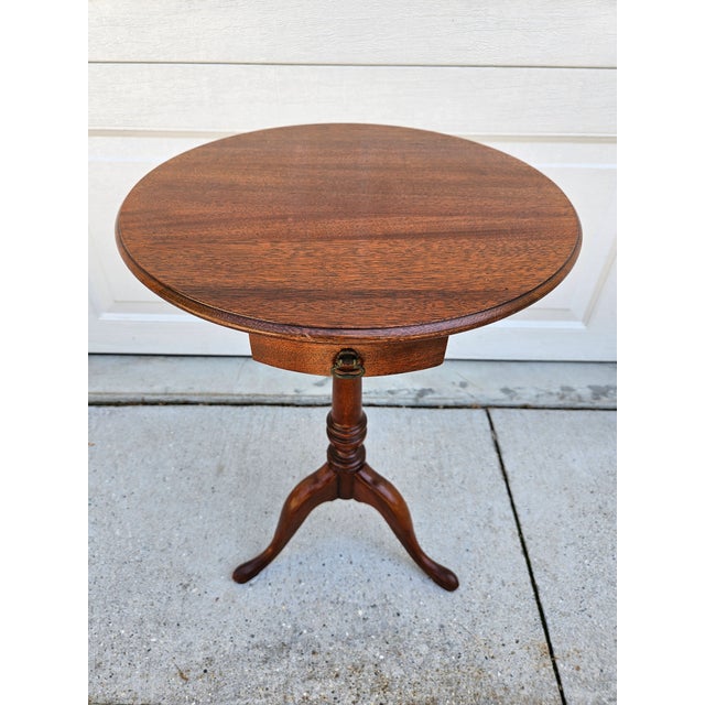 A beautiful round mahogany pedestal table with a shallow drawer. This piece could be used as a petite side table, drinks...