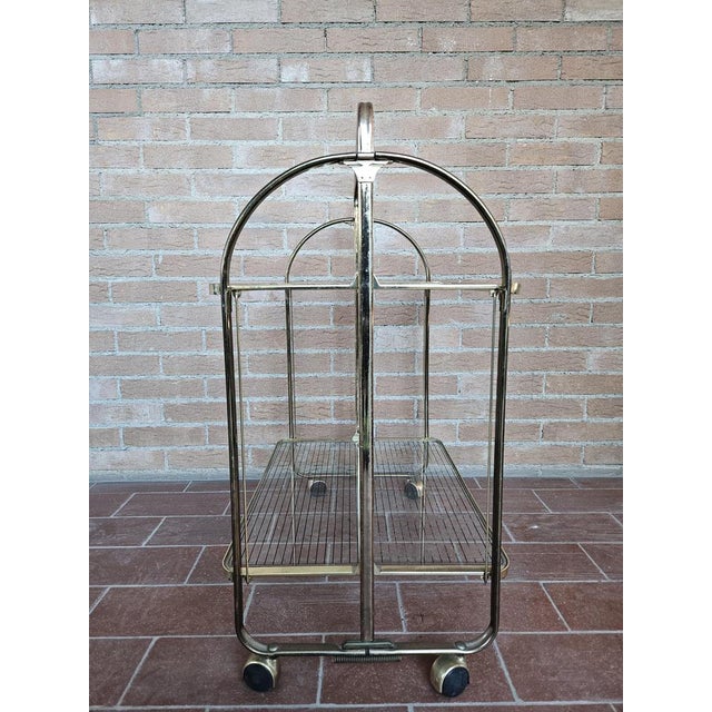 Brass room trolley with double glass shelf and original vintage wheels. Normal wear signs due by age and use.