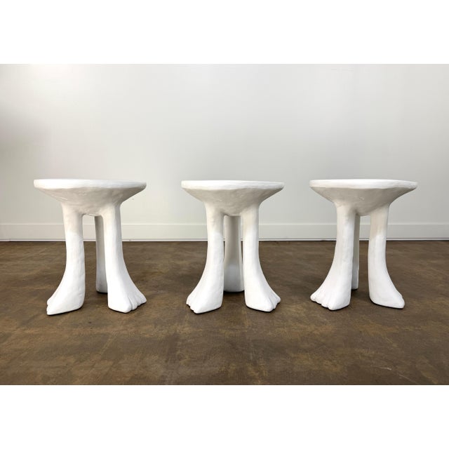A striking and highly decorative set of three sculptural "African" side tables designed by John Dickinson and produced by...