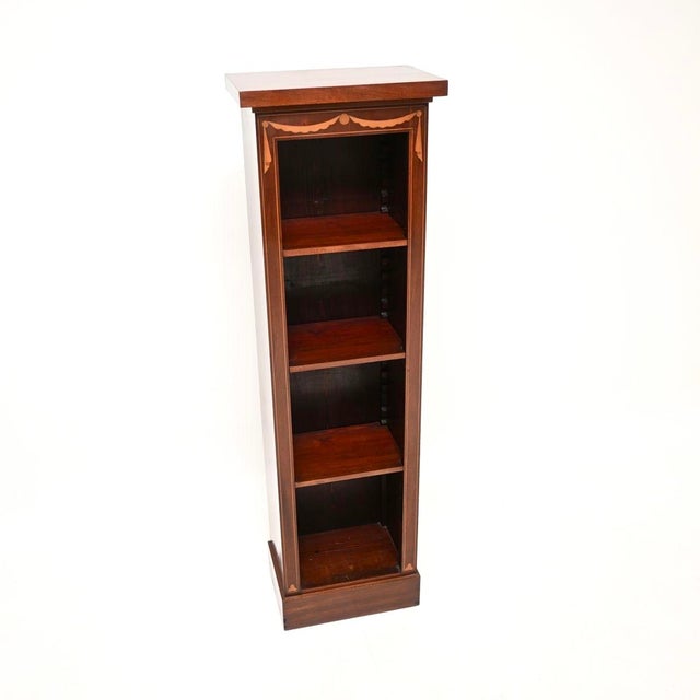 An extremely well made and very smart antique slim inlaid open bookcase in the Georgian style. This was made in England,...
