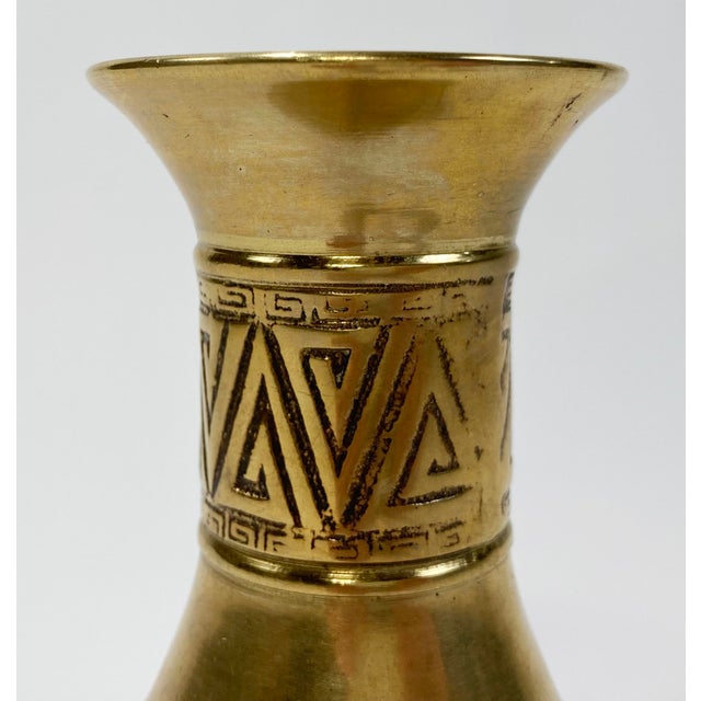 Vintage solid brass vase with Korean markings. Features two stylized borders in relief. Heavy. Lovely patina.
