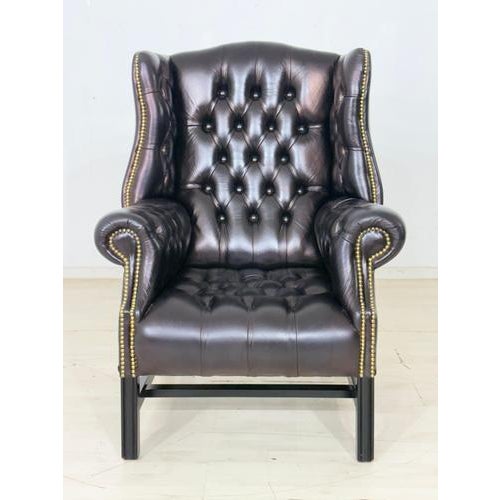 Elegant Chesterfield wingback chair by Wilmowsky in exquisite burgundy leather. The chair impresses with its classic...