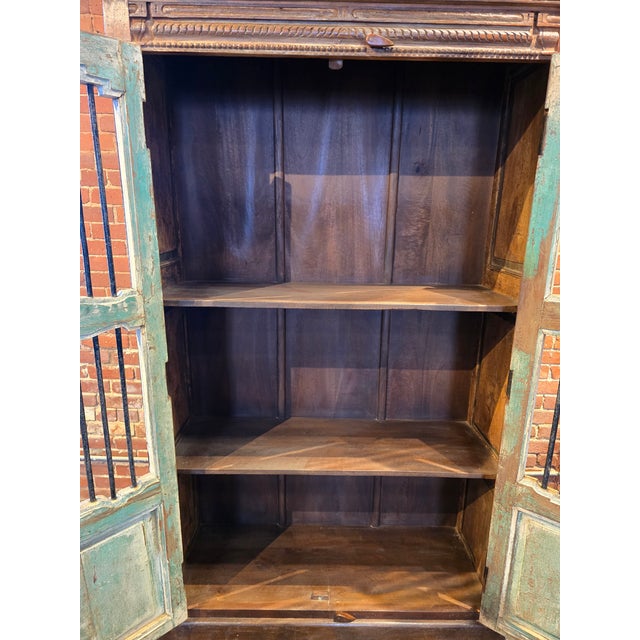 Bring a touch of rustic history and architectural interest to your home with this striking, one of a kind armoire. Hand-...