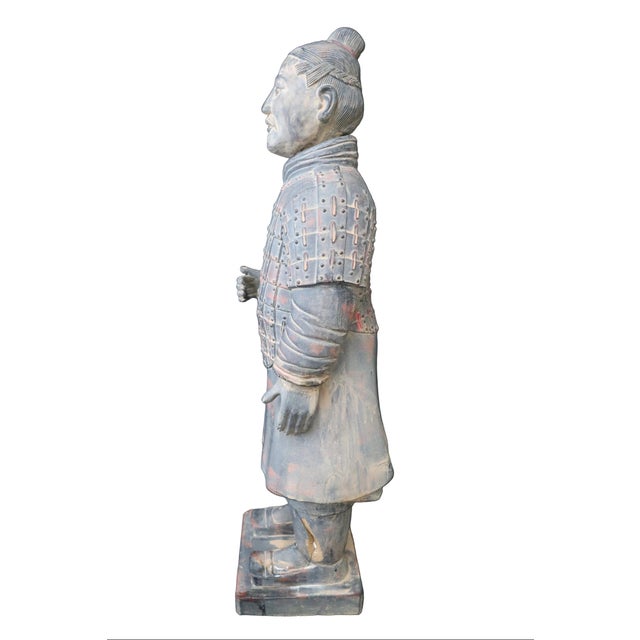 Made in Xi'an, this small scale reproduction of a terracotta warrior stands at 30 inches tall and is recognizable as an...