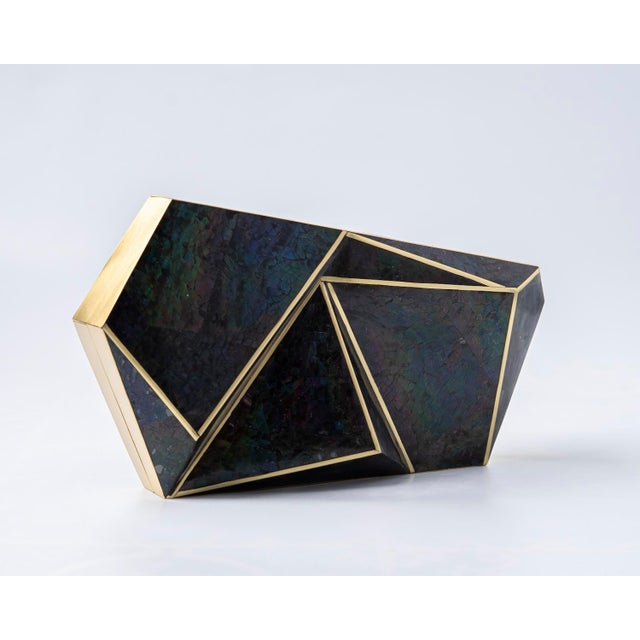 Inspired by the bold modernity of Porto’s Casa da Música, the AZURA Asymmetrical Minaudière is a striking expression of...