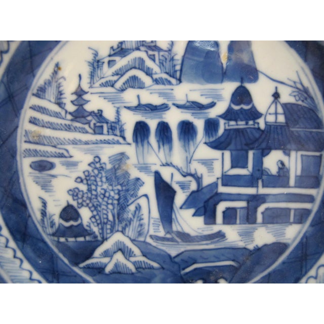 Chinese export Canton blue and white porcelain dish. Traditional pattern showcasing a detailed, hand-painted landscape of...
