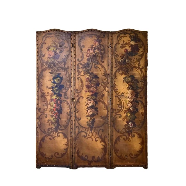 A late 19th century three-panel screen, hand-painted on canvas in the Rococo taste featuring an elegant array of...