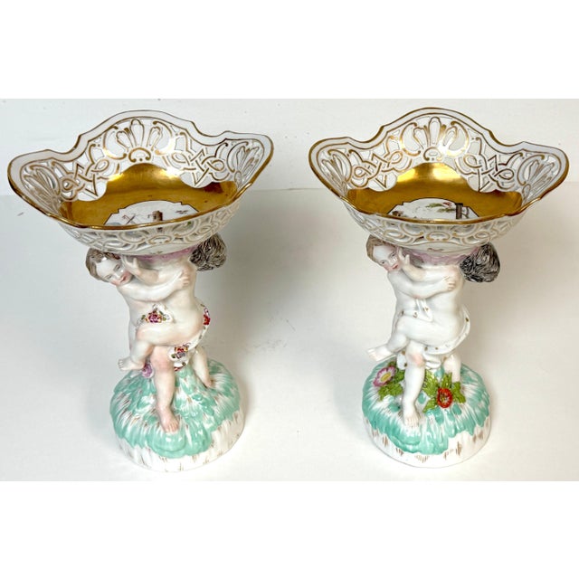 Pair of KPM Berlin Porcelain Figural Tazza with Reticulated Gilt Baskets, Putti Supports & Hand-Painted Ruin Landscapes,...