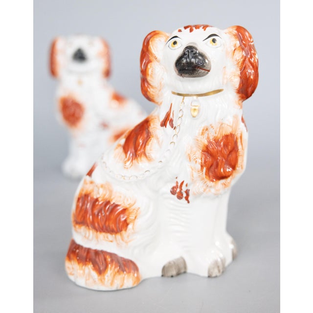 A fine pair of antique 19th-Century English Staffordshire russet Cavalier King Charles Spaniel mantel dogs. These charming...